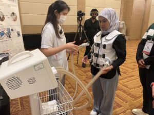 PICU nurse testing the HFCWO vest at Sunway Medical PICU Course
